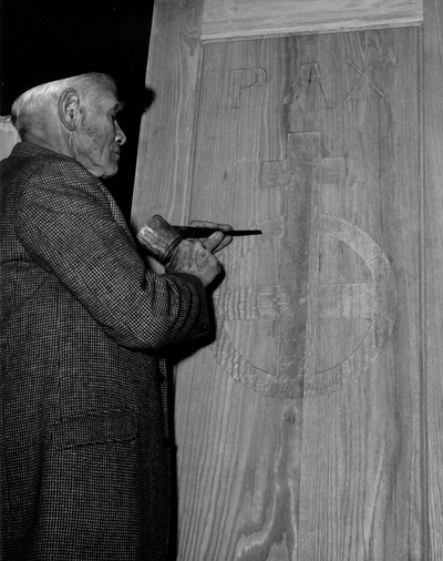 John Jacob Niles carving the doors for St. Hubert's Church, Boot Hill Farm; Jack Cobb