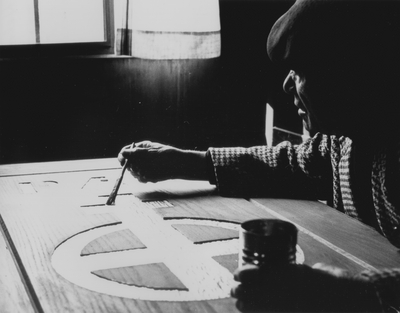 John Jacob Niles working on doors for St. Hubert's Church; Van Coke