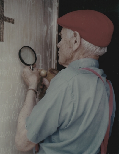John Jacob Niles puts the finishing touches on carving of doors for St. Hubert's Church; Lexington Herald-Leader