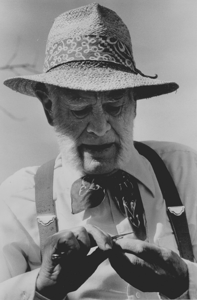 John Jacob Niles scoring a moon-vine seed to speed germination; Boot Hill Farm; Kerby Smith