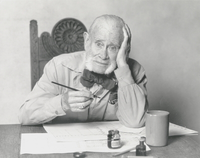 John Jacob Niles working on a music manuscript at dining room table; Boot Hill Farm; Steve Mitchell