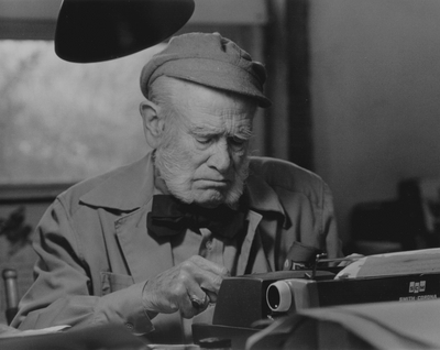 John Jacob Niles working on autobiography at typewriter in pony barn, Boot Hill Farm; Steve Mitchell