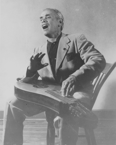 John Jacob Niles seated with dulcimer pose-used most often for publicity; Van Coke