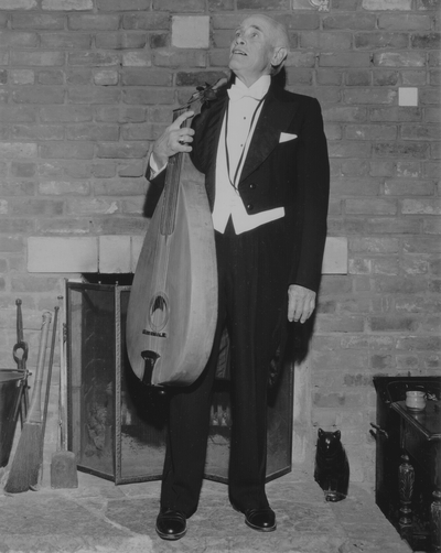 John Jacob Niles in evening dress with dulcimer, posed at Boot Hill Farm; Jack Cobb