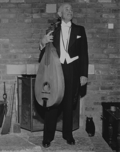 John Jacob Niles in evening dress with dulcimer, posed at Boot Hill Farm; Jack Cobb