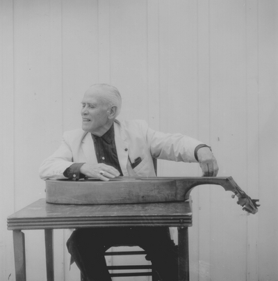 John Jacob Niles posed with dulcimer; Boot Hill Farm; Eugene Meatyard