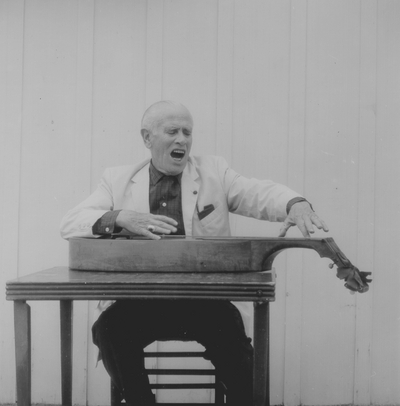 John Jacob Niles posed with dulcimer; Boot Hill Farm; Eugene Meatyard