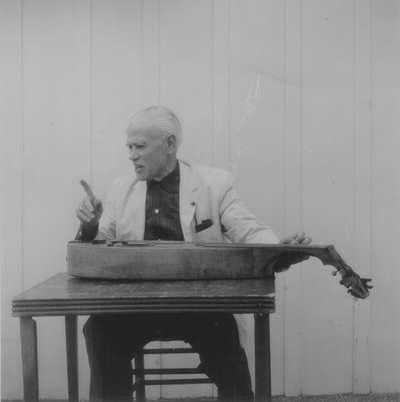 John Jacob Niles posed with dulcimer; Boot Hill Farm; Eugene Meatyard