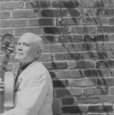 John Jacob Niles posed with dulcimer; Boot Hill Farm; Eugene Meatyard