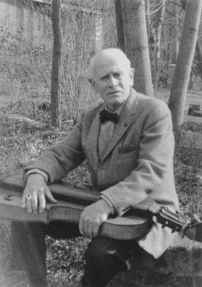 John Jacob Niles outdoors holding dulcimer, Boot Hill Farm; Sallie Aulabaugh