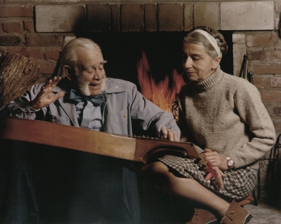 John Jacob Niles and Rena Niles in front of fireplace; Boot Hill Farm; Tony Leonard