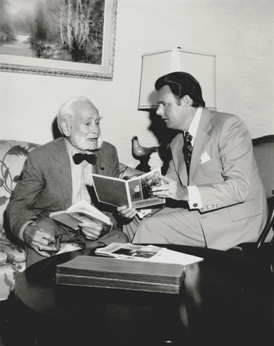 Tom Barnes (right), Trust Officer Citizen's Union Bank with John Jacob Niles used for bank calendar