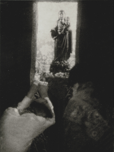 Posed before a statue of the Virgin, John Jacob Niles and Doris Ulmann's maid.  Printed on photo papers, folded and sent as a Christmas card; Doris Ulmann