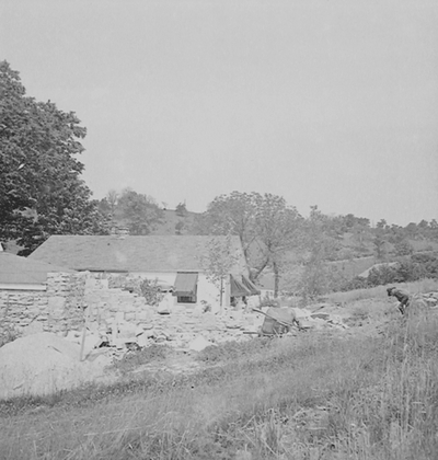 Robert Hicks building a stone wall at Boot Hill Farm