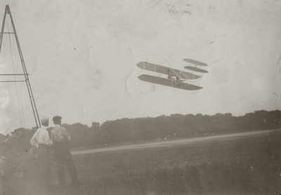 Wilber Wright and mechanic Taylor watching Orville Wright fly; Paul Thompson