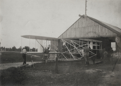 Wright Brothers' aeroplane leaving the barn to be put on the slide; Paul Thompson