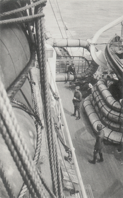 Photo on board ship: military personnel below on deck