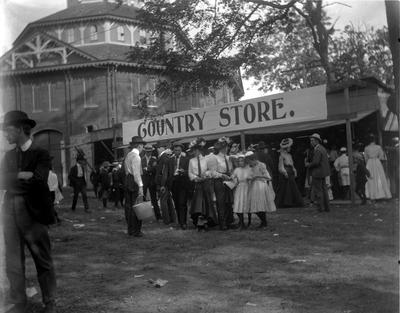 1902 Elks Fair, Lexington Trotting Track, people milling around County Store