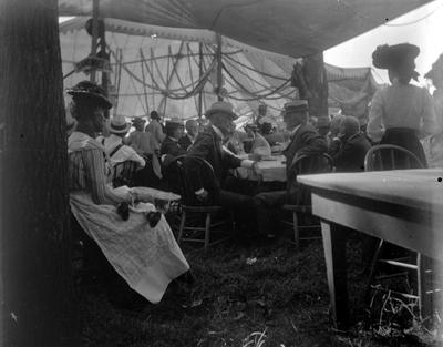 1902 Elks Fair, group of people sitting under a tent