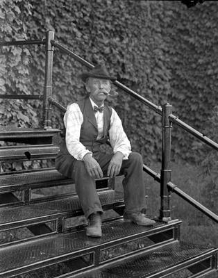 man sitting on bleachers