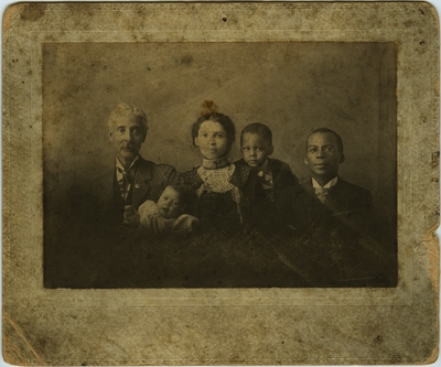 The family of R.C.O. [Robert Charles O'Hara] Benjamin. Picutured in the photograph are Robert Charles O'Hara Benjamin, 45, Lulu Maria Benjamin, 27, Robinson Charles O'Hara Benjamin, 4, Lillian Allen Benjamin, 4, and grandfather W.S. Robinson, 53; written on the back of the photo 