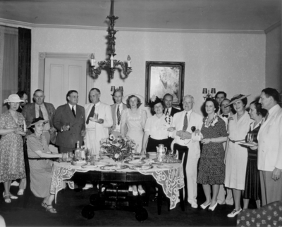 Reception; group of men and women around a serving table