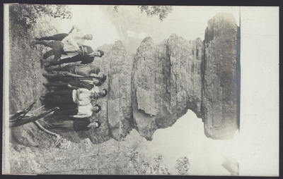Hiking Scene, Nine Men in Front of a Rock