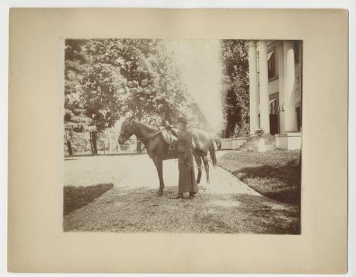 Clara D. Bell, as a young adult, with horse
