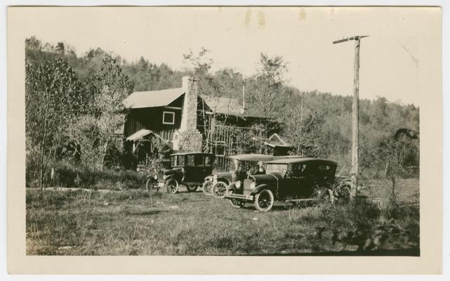 A cabin with automobiles in front, Cliff Echoes, down on Kentucky River camping