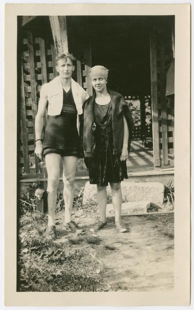 Wolfe [man on left wearing a bathing suit with a towel draped around his neck], played in university orchestra.  Ethel [on right, wearing a bathing cap] married Count.  Both are standing in front of a porch