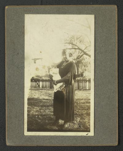 Portrait of an unidentified black woman holding a baby