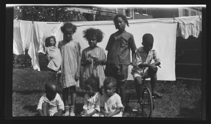 Negative of a group of unidentified young boys and girls