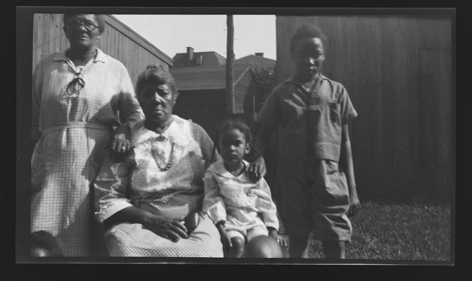 Negative of two unidentified women and two children