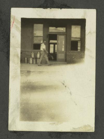 Page 13: Unidentified black man walking in front of entrance to a building