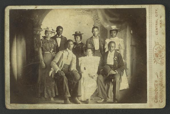 Group portrait of unidentified young black men and women, note on back reads Tommie M. Jenkins