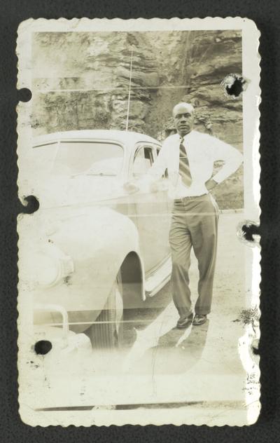 On top of Norris Dam, Florizel Wilson posing with car