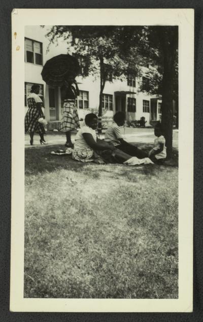 Mary Alice Warren [far left] and four unidentified black people in the grass