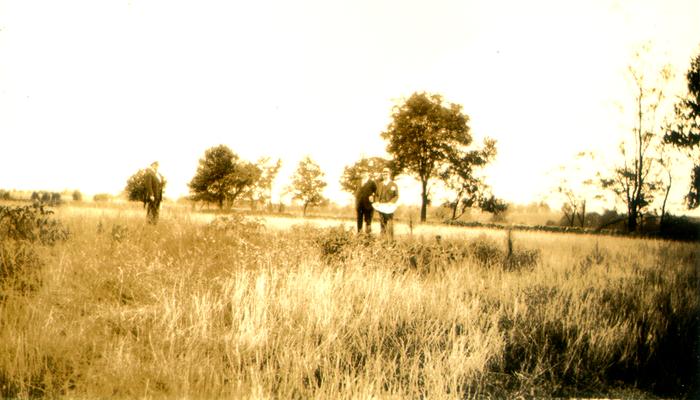 Three men in a field