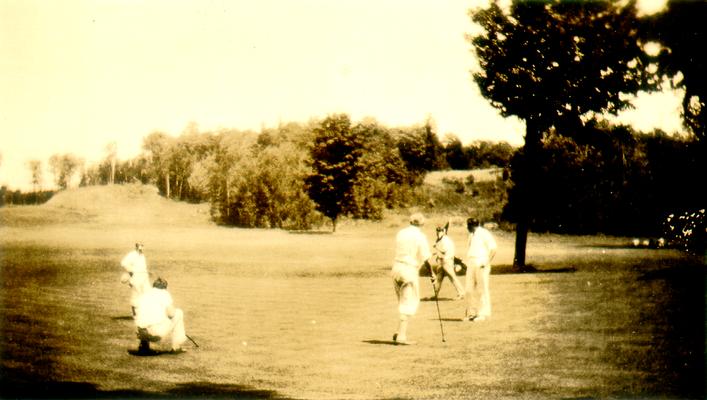 Five men on a golf green