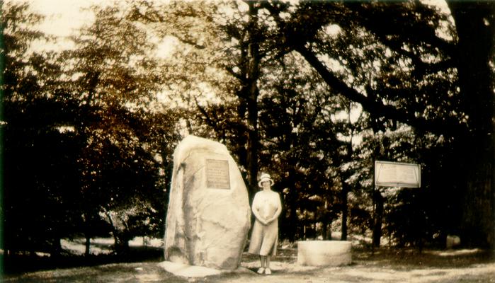 Mary Shelby Wilson standing beside a memorial marker