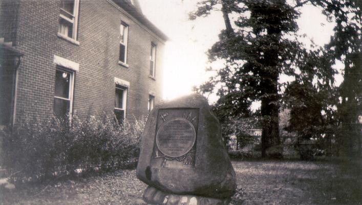 Marker on lawn of two-story building