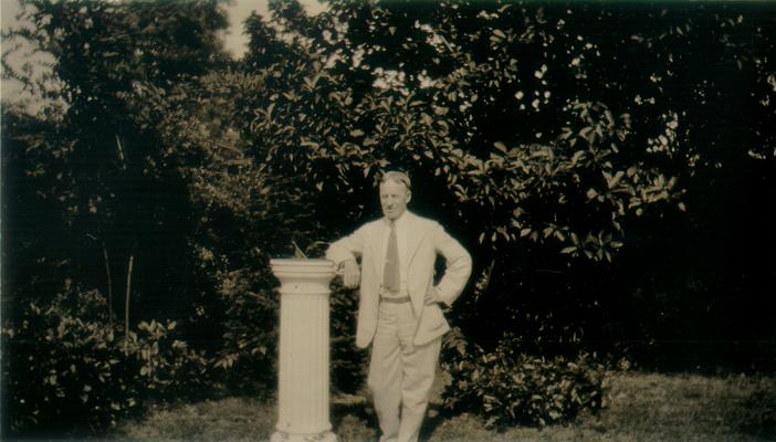 Man leaning on a sun dial