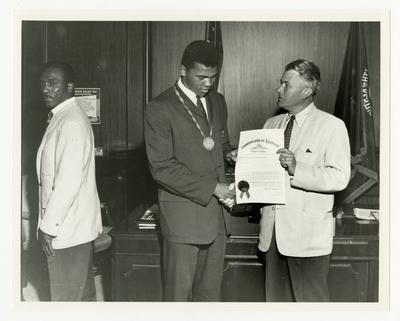Kentucky Governor Bert T. Combs presenting an award to Muhammad Ali