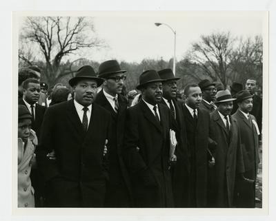 Dr. Martin Luther King, Jr., with group of men leading the march. Ralph David Abernathy is second man from King's right and Frank Stanley Jr. is fourth man from right