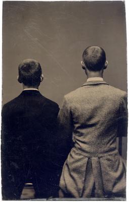 Two unidentified men, with backs turned toward camera
