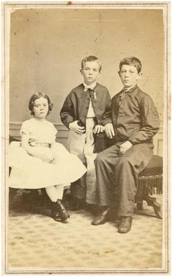 Unidentified girl with two boys, handwritten on back in ink 