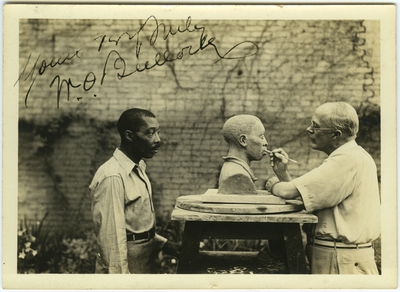 Dr. Waller Overton Bullock sculpting the bust of an unidentified African American man