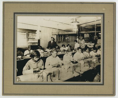 Domestic science class at Lincoln Grant High School in Covington, Kentucky picturing unidentified students, an unidentifed man, and teacher Lillian Crutchfield