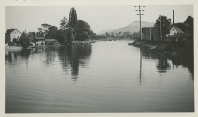 Water, houses along the shore.  