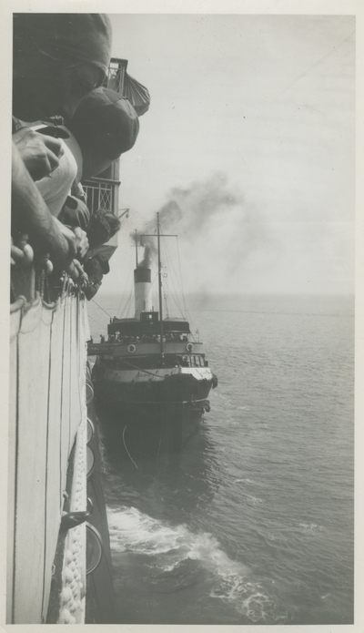 Boat alongside ship.  